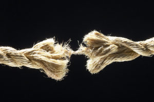 Rope - fraying-brown-fiber-rope-against-black-background-1